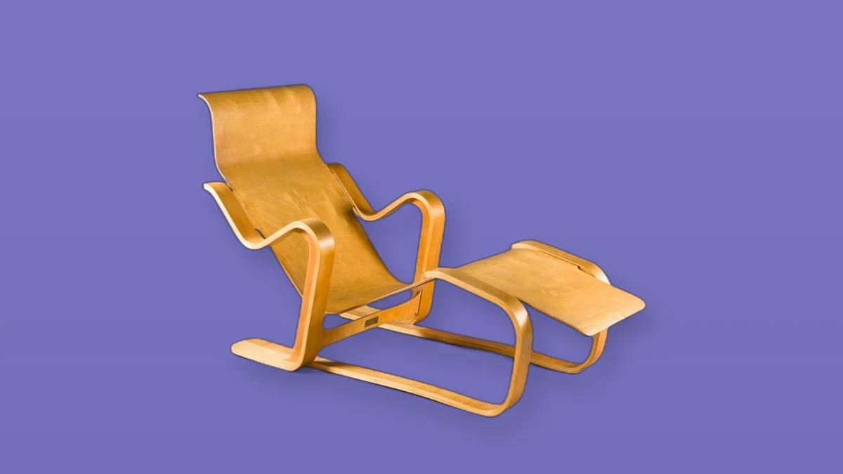 An empty wooden lounge chair photographed on a violet background