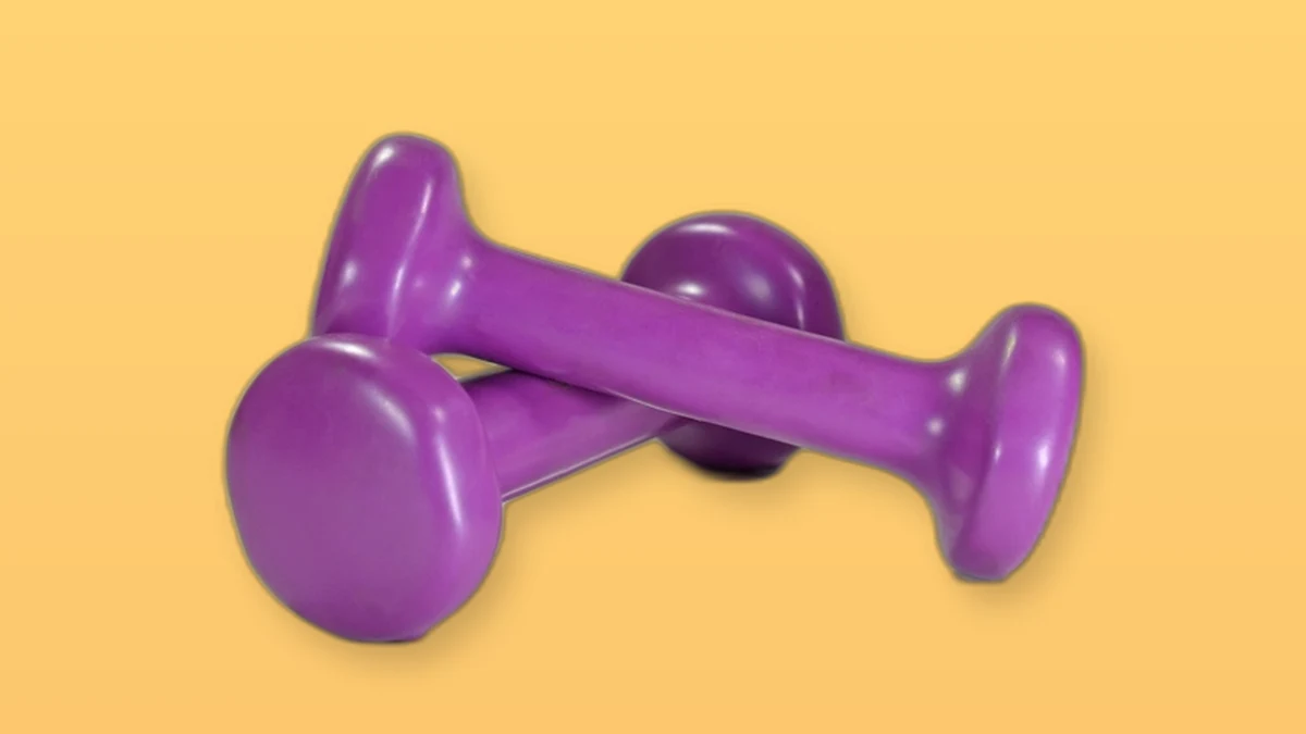 Photo illustration of a pair of purple dumbbells on a warm peach background