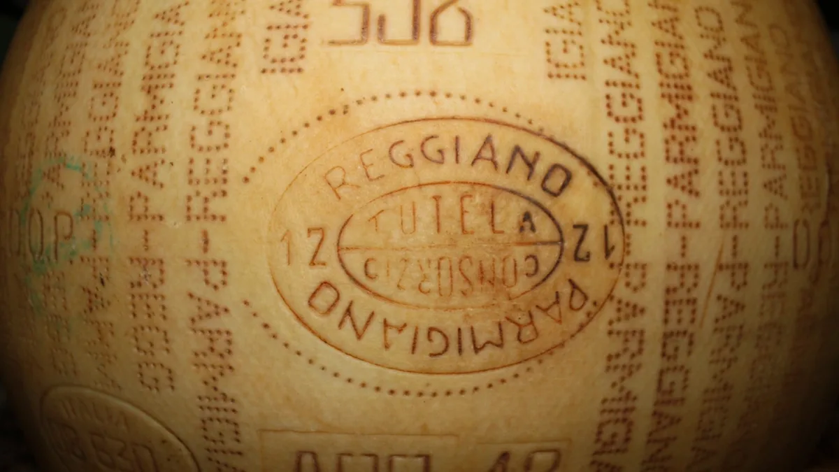 Close-up of a stamped Parmigiano Reggiano cheese wheel rind