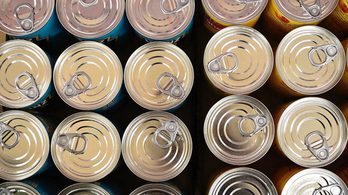 Overhead view of rows of canned food tops with pull tabs