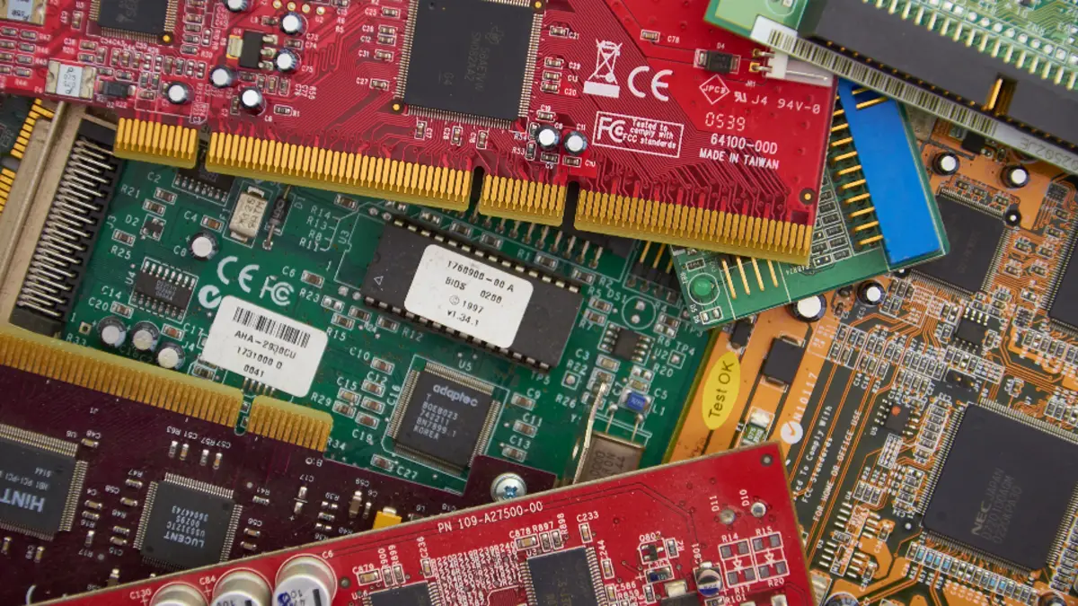 A stack of colorful computer circuit boards and processor chips