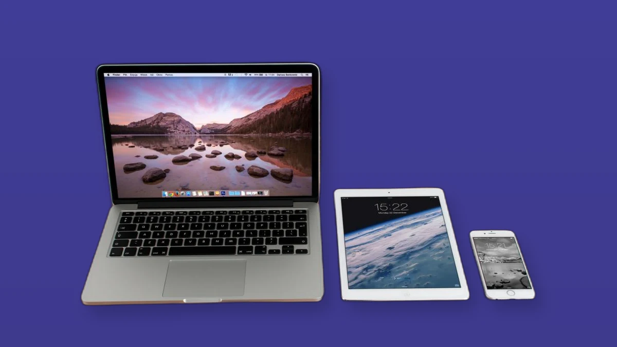 A laptop, tablet, and smartphone arranged on a violet background