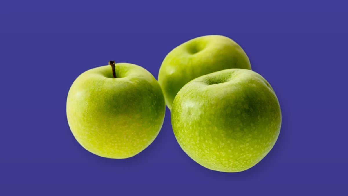 Three green apples on a deep violet background