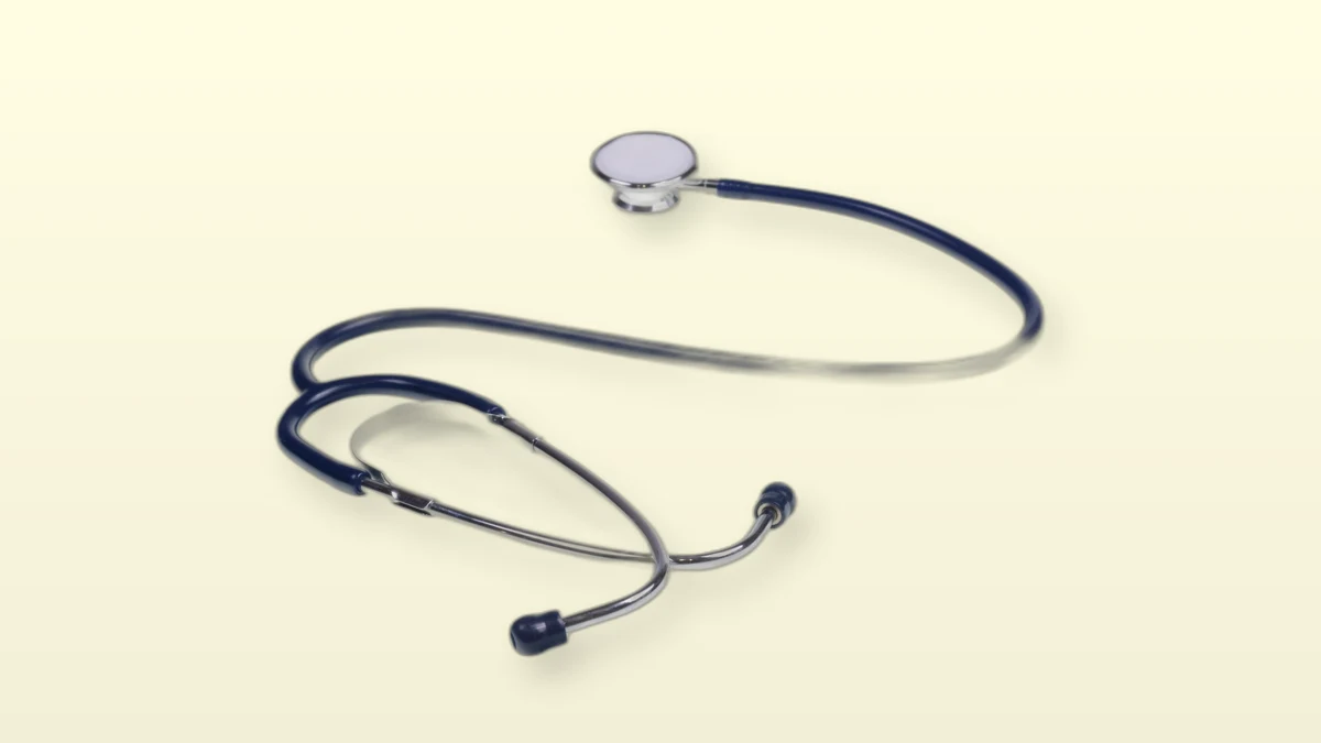Photo illustration of a navy blue stethoscope on a cream background