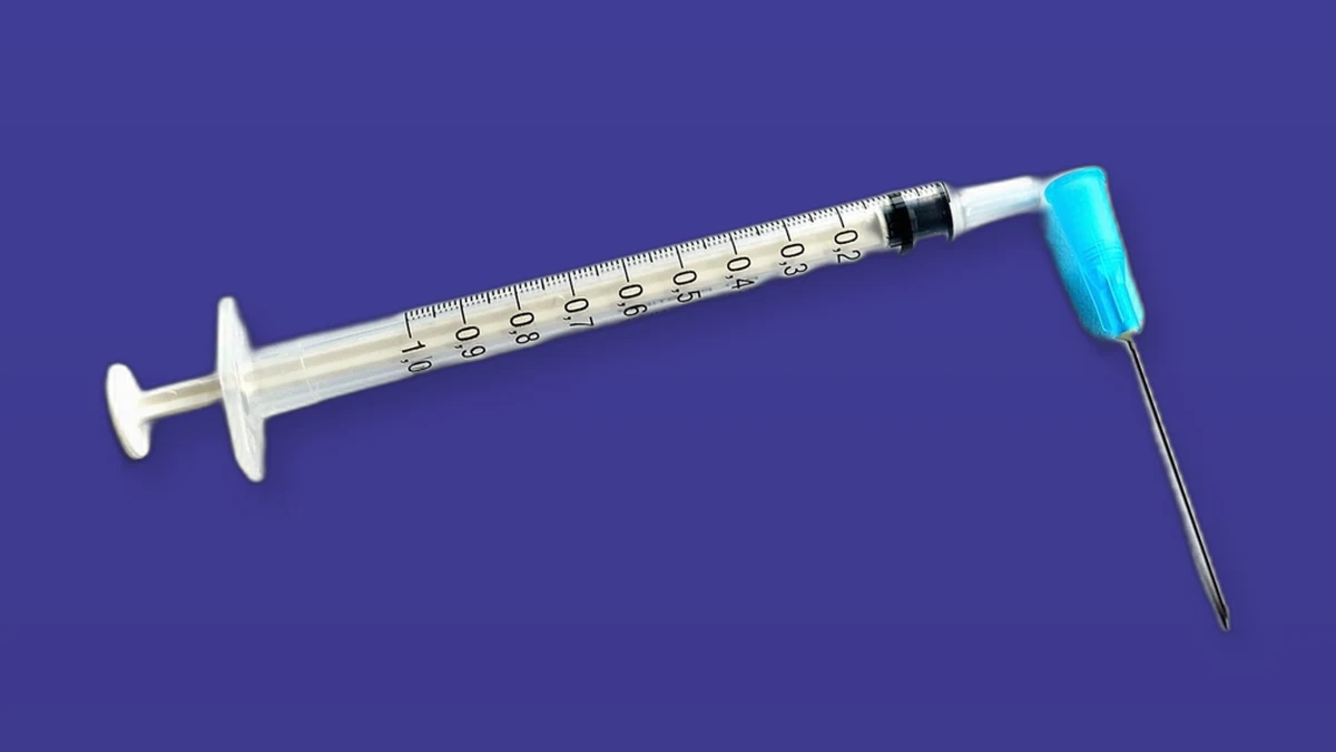 Photo illustration of a medical syringe and needle set against a violet background.