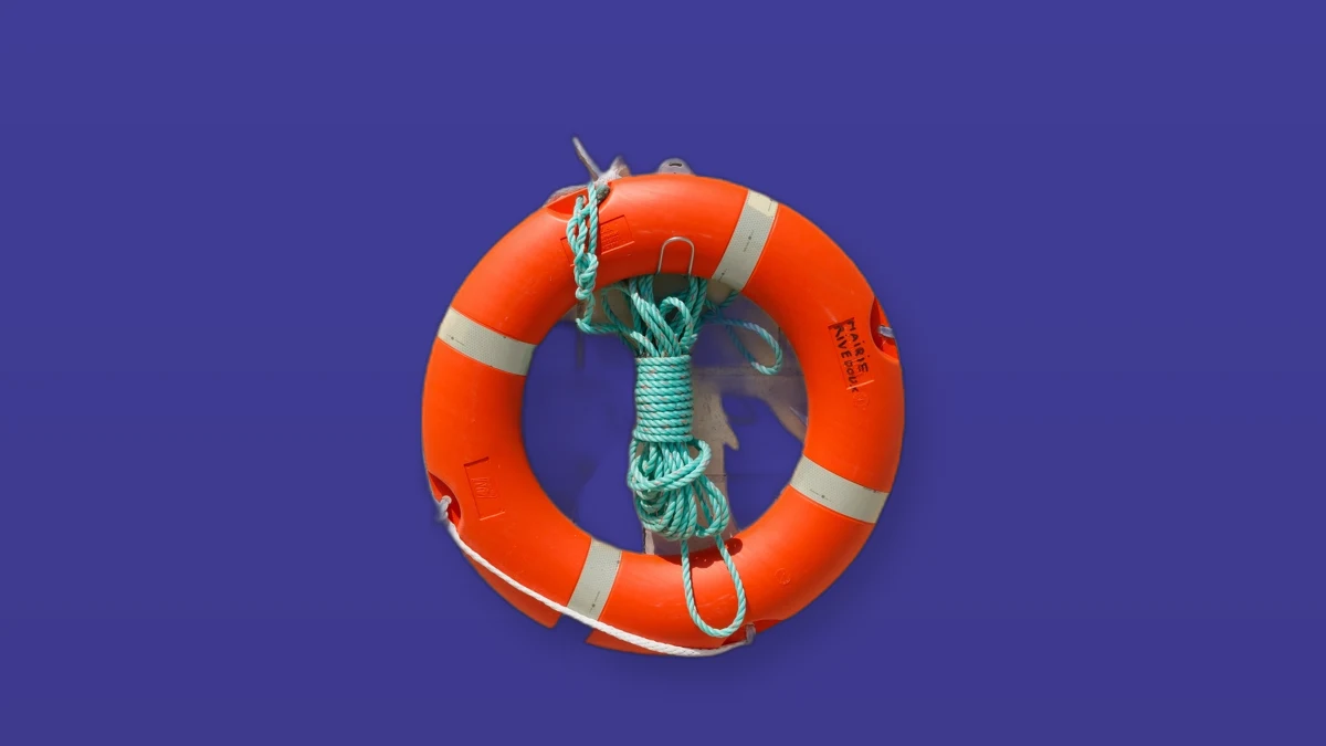 Photo illustration of an orange life ring buoy on a deep violet background