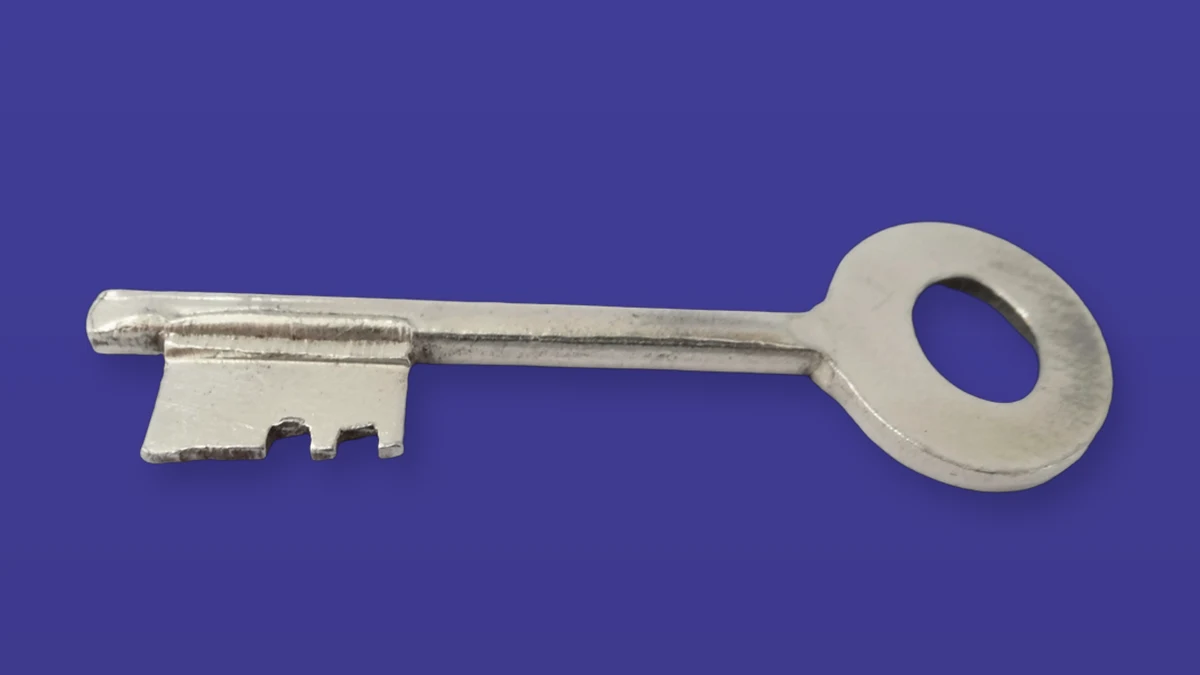 A metal key isolated on a violet background to symbolize secure access
