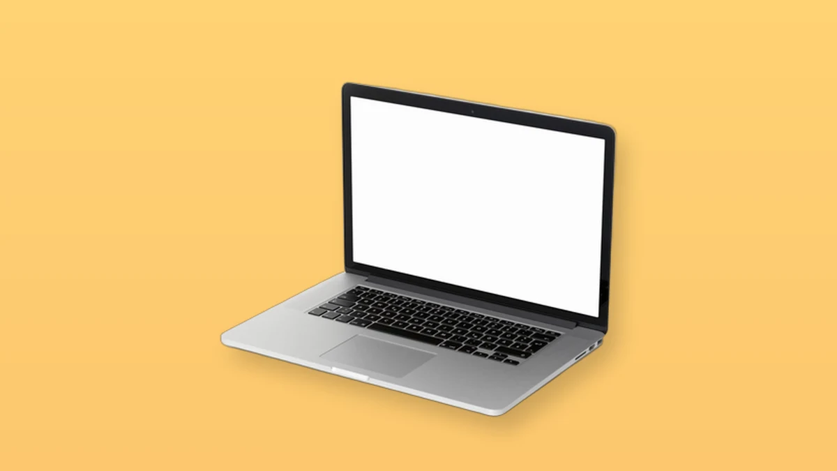 An open laptop isolated on a warm peach background