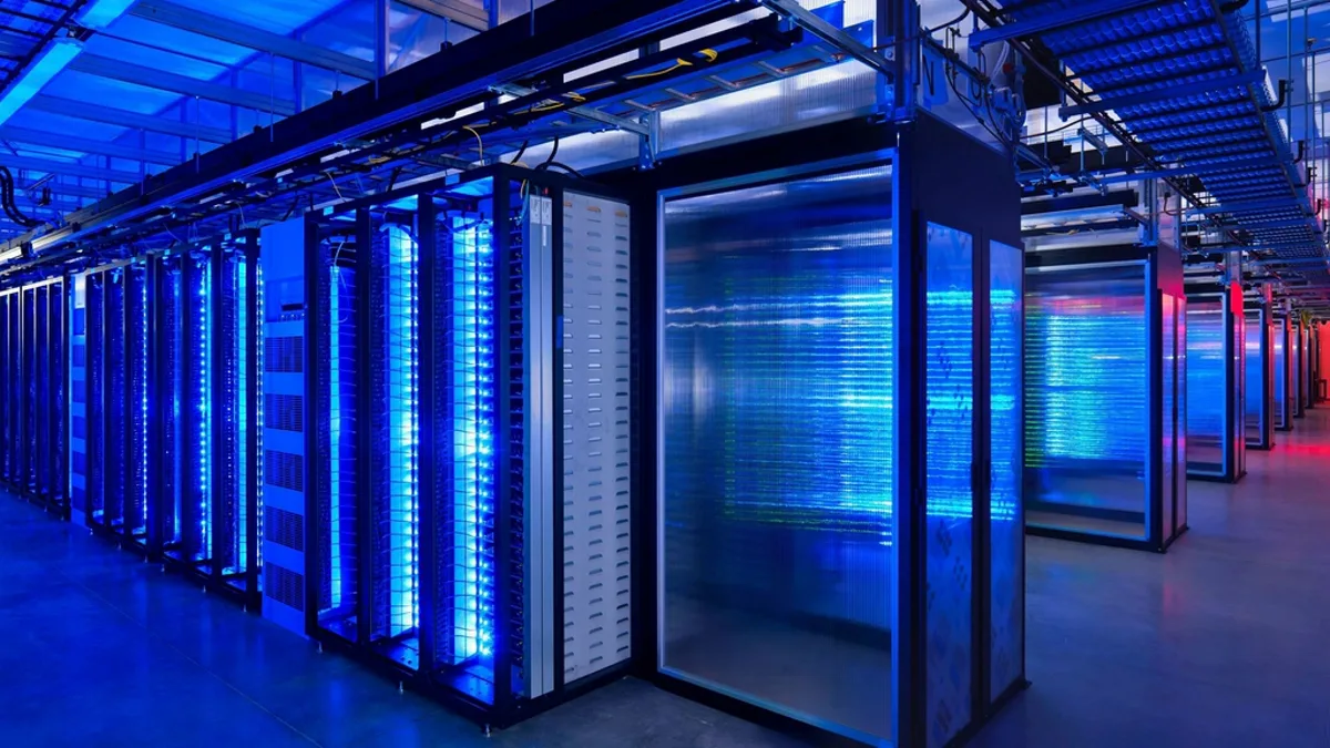 Rows of illuminated blue server racks inside a large data center