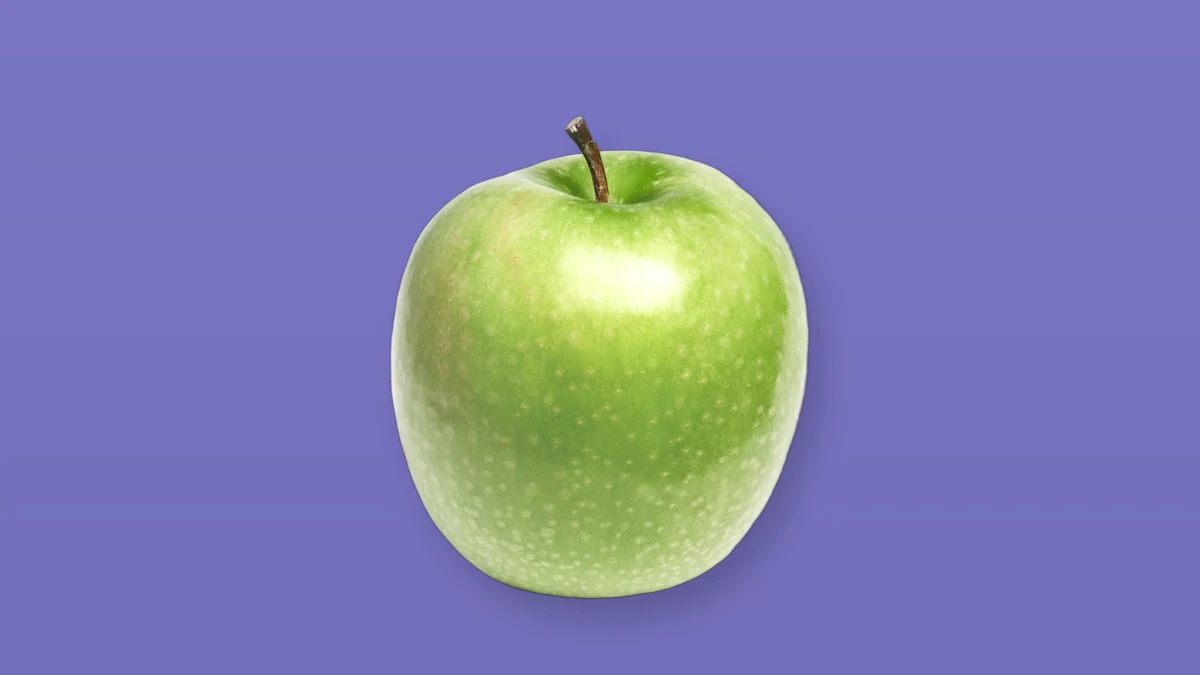 Green apple isolated on a lavender background