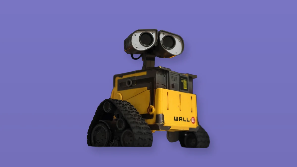 Yellow tracked robot isolated on a lavender background