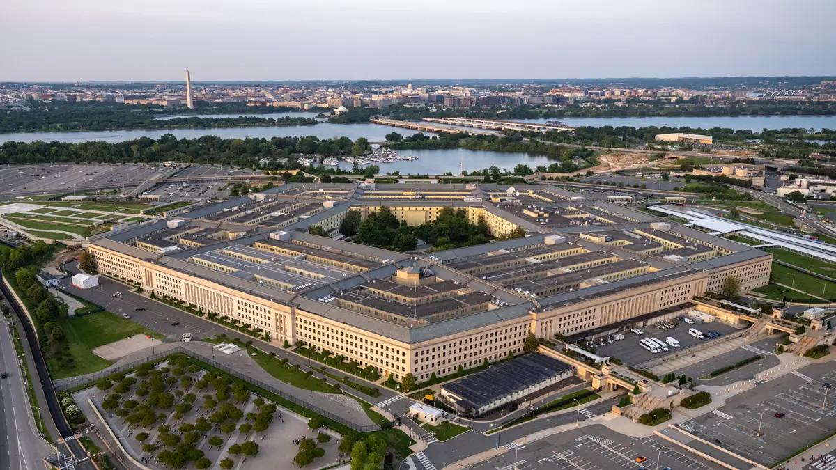 Aerial view of the Pentagon in Arlington, Virginia, with the Potomac River and Washington, D.C. skyline behind it