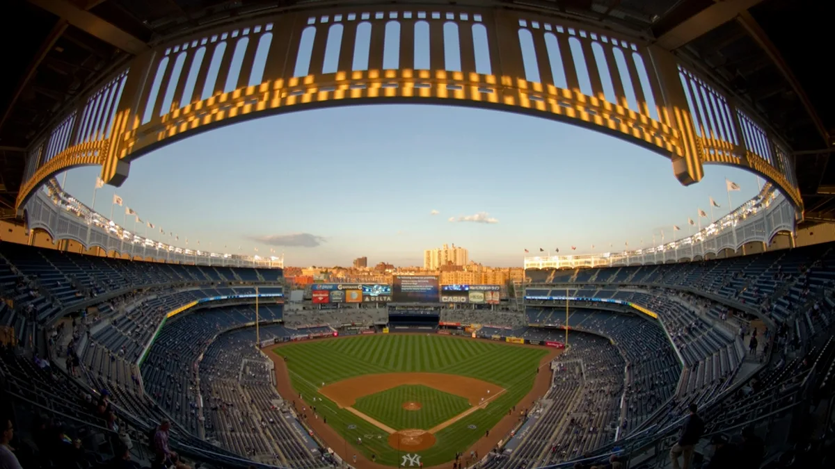 Wide view of the Yankee Stadium field and stands from the upper deck at dusk