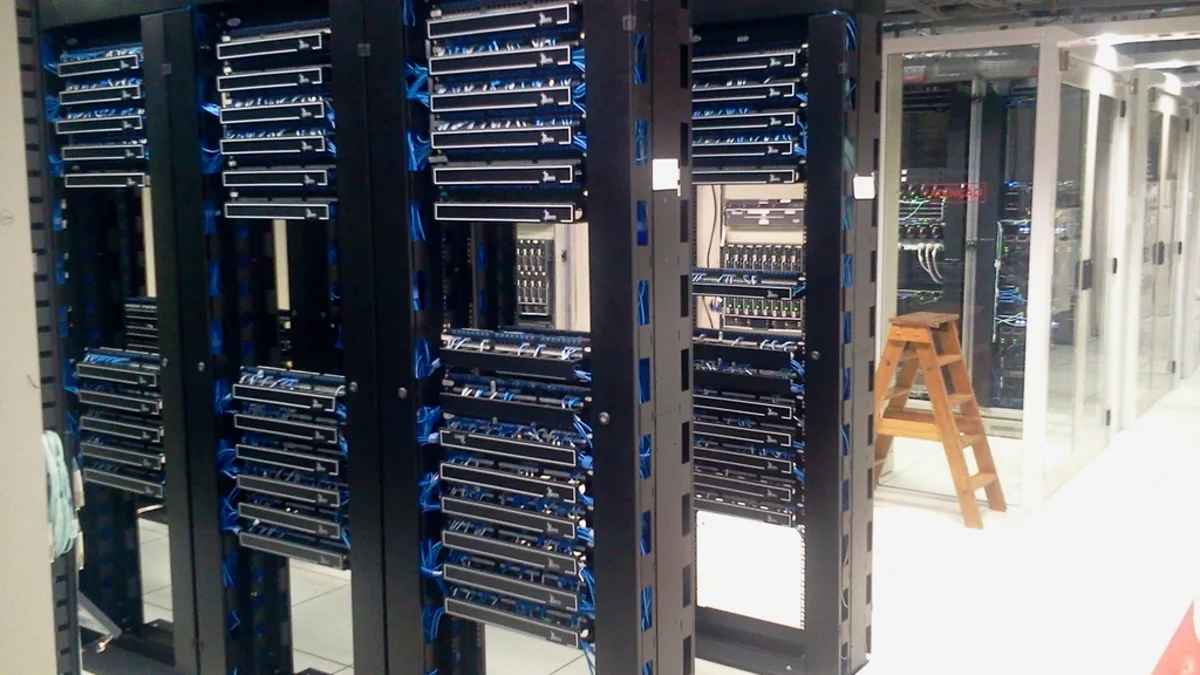 Rows of networking and server racks inside a data centre