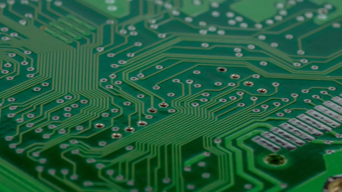 A green printed circuit board photographed in close-up