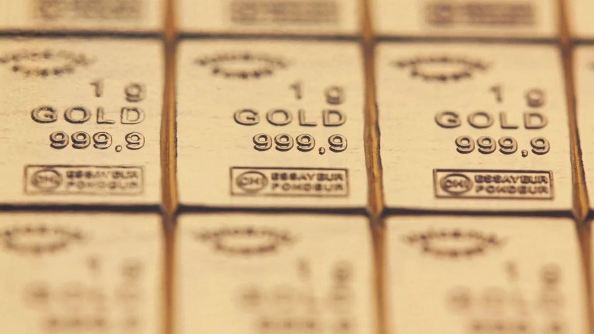 Rows of stamped gold bars laid out side by side