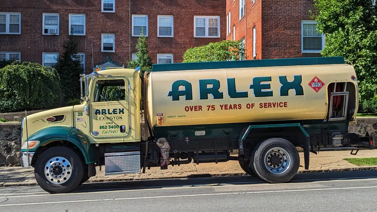 A heating oil delivery tanker truck parked on a residential street in Massachusetts