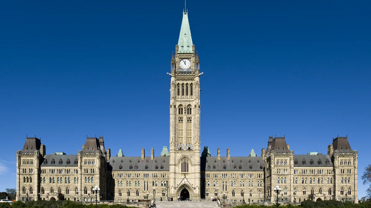 The Centre Block and Peace Tower of Canada's Parliament Hill in Ottawa under a clear sky