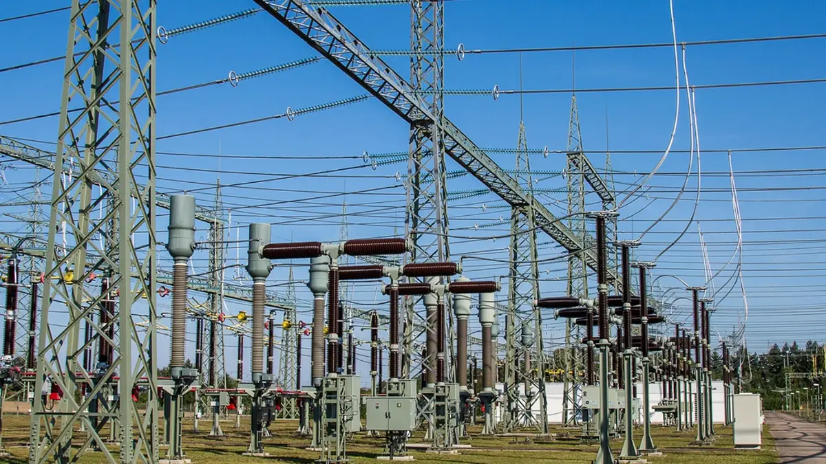 High voltage transmission equipment and insulators at an electrical substation switchyard