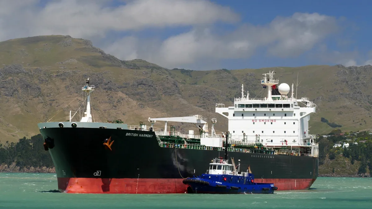 An oil and chemical tanker escorted by a tugboat in coastal water