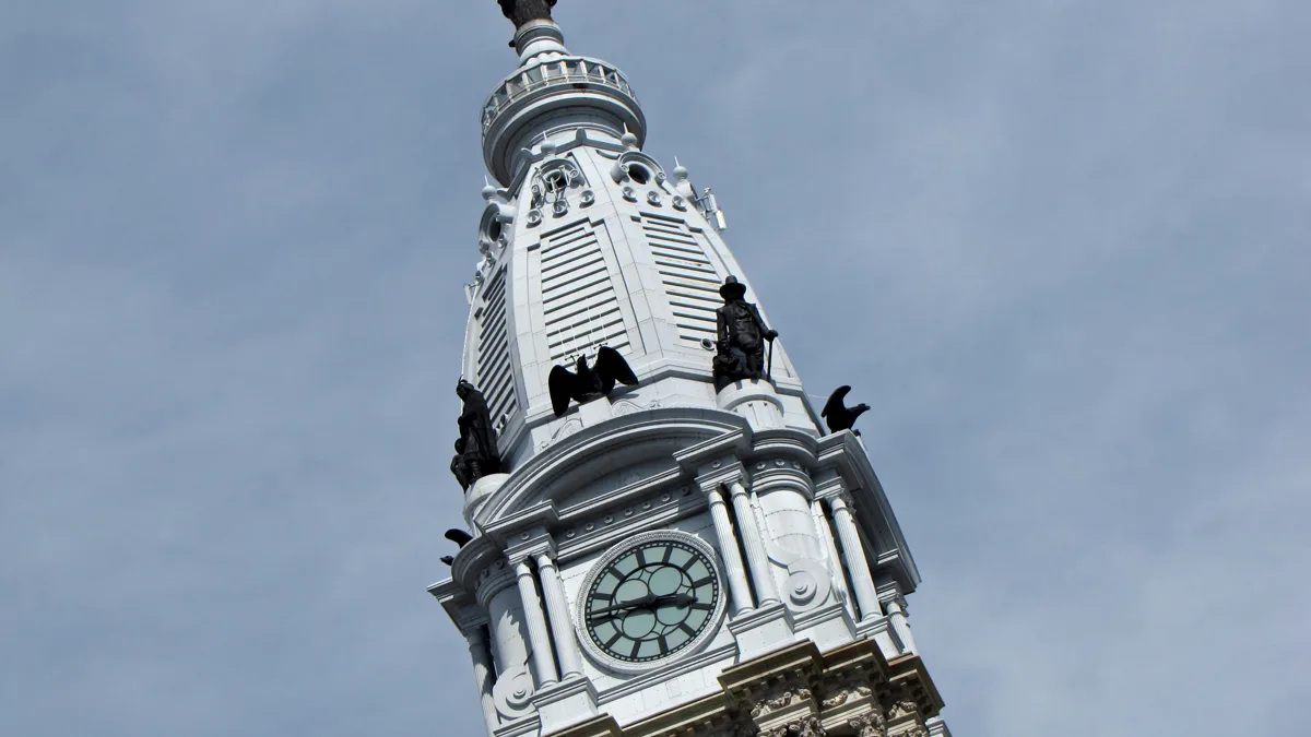 The clock tower of Philadelphia City Hall topped by the William Penn statue