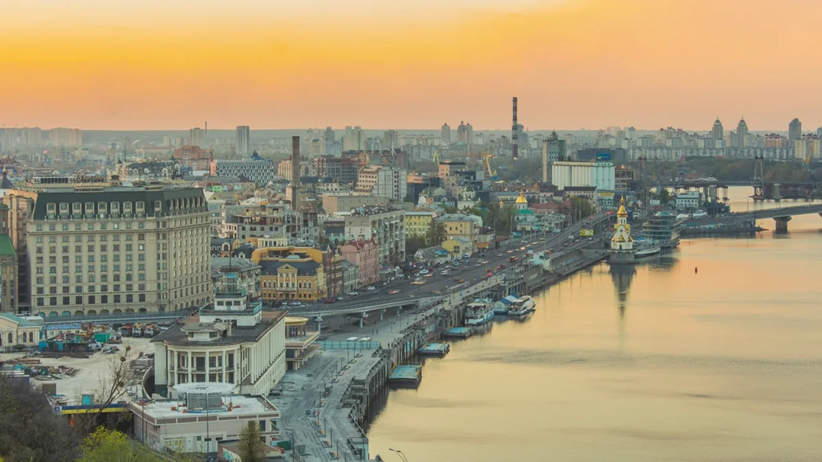 Kyiv skyline and the Dnipro River at sunset