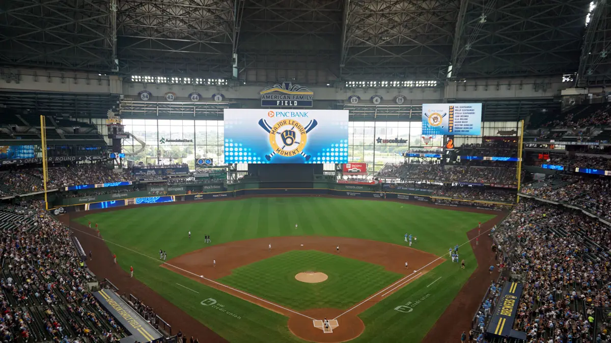 Interior view of American Family Field in Milwaukee during a Brewers game, with the scoreboard and crowd