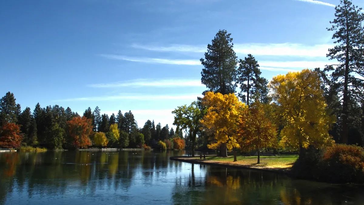 Autumn trees reflected in the river at Drake Park in Bend, Oregon