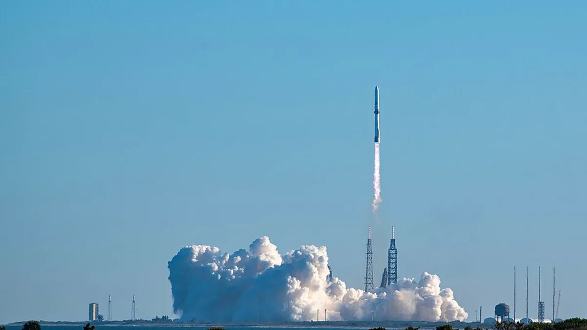 A Blue Origin New Glenn rocket lifting off from a launch pad in Florida
