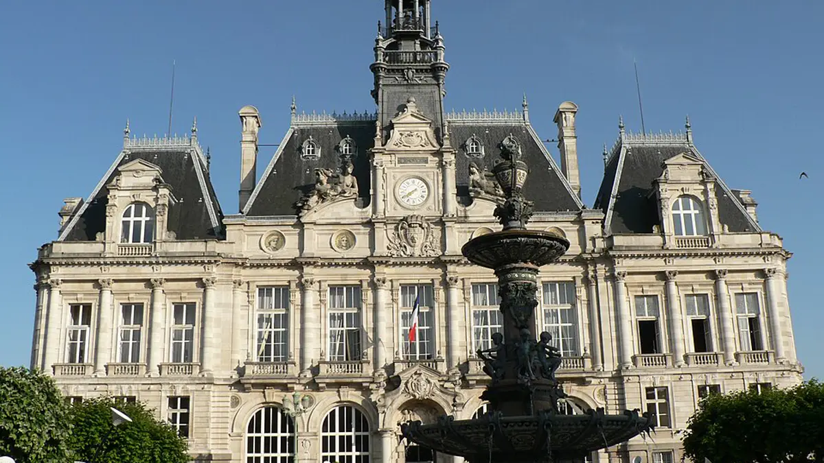 The stone facade and clock tower of the Limoges town hall in France