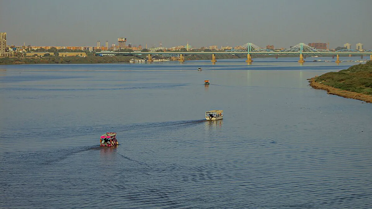 Boats on the Nile in Khartoum, Sudan, with a road bridge and the city skyline behind