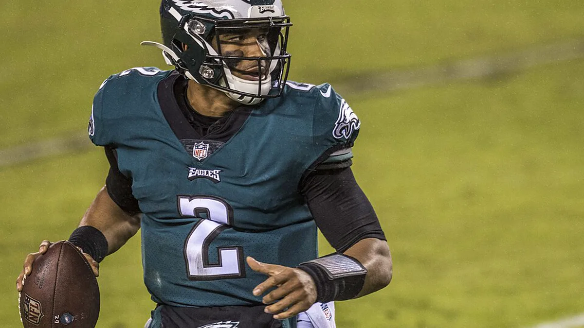 Philadelphia Eagles quarterback Jalen Hurts rolling out with the football during a 2020 game