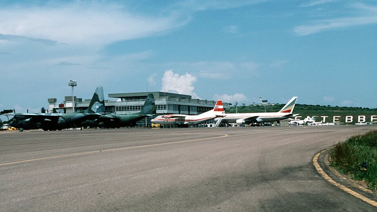 The terminal and apron at Entebbe International Airport in Uganda, with the Entebbe hillside sign behind