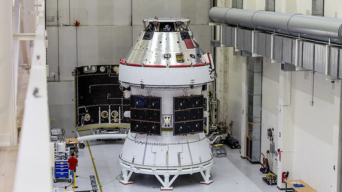 NASA's Orion spacecraft crew module and service module stacked inside a Kennedy Space Center high bay