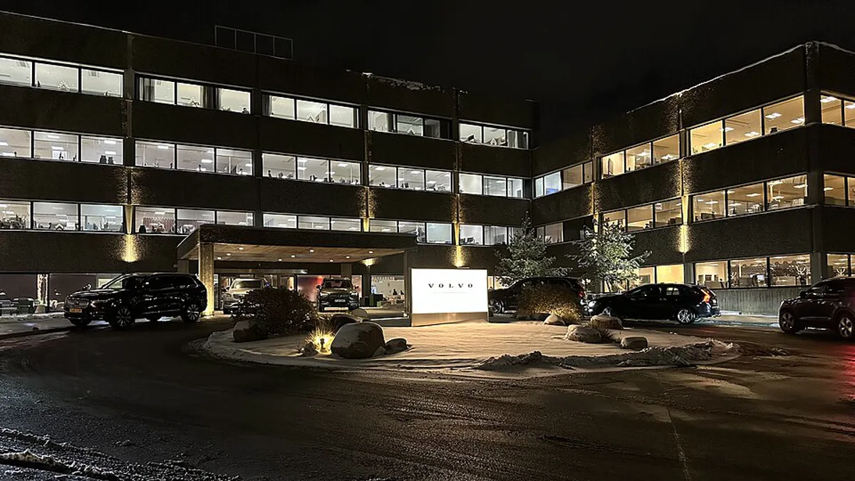 The lit entrance of Volvo Cars headquarters in Gothenburg, Sweden, photographed at night